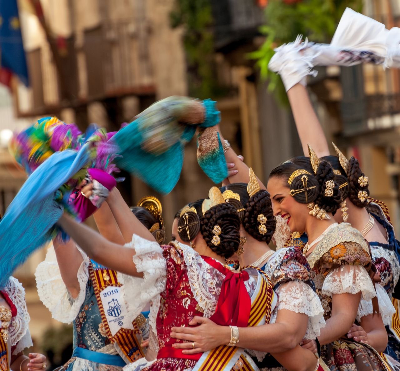 Services Women in traditional Spanish attire celebrate a cultural festival in Valencia with vibrant dances and festive spirit.