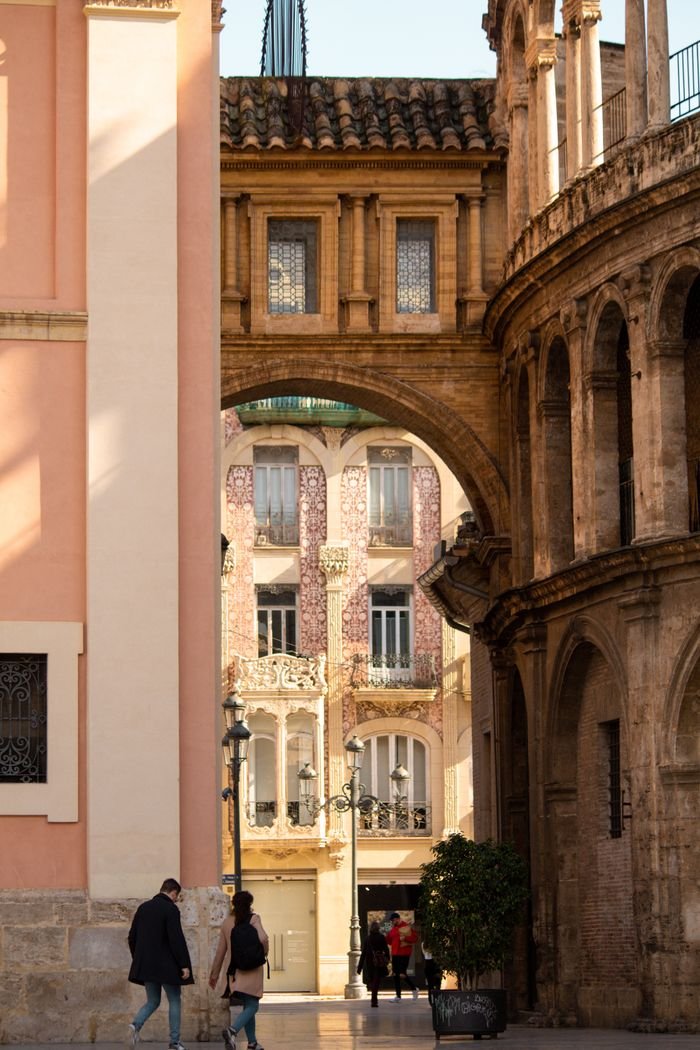 Services Beautiful stone arches and historic buildings in Valencia's old town, Spain.