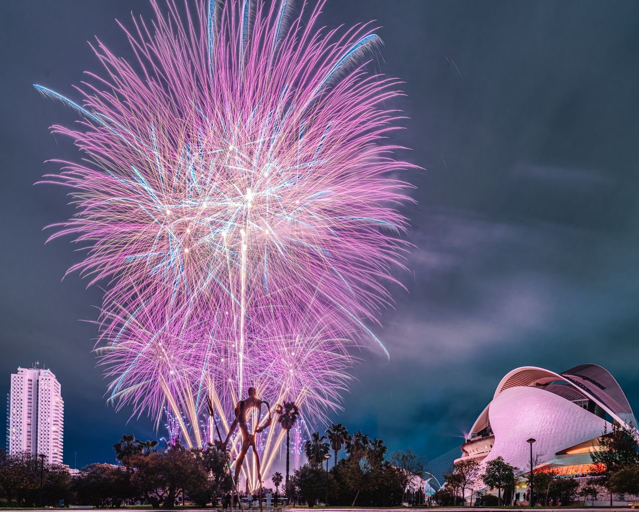 Home Vibrant fireworks illuminate a modern city skyline, highlighting iconic buildings against the night sky.